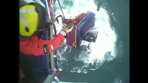 Helicopter rescue of fishermen from a sinking boat