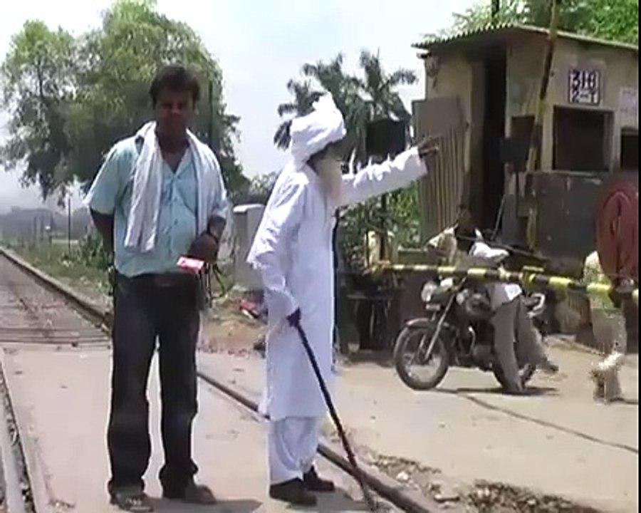An old man performing stunt right front of moving train...........