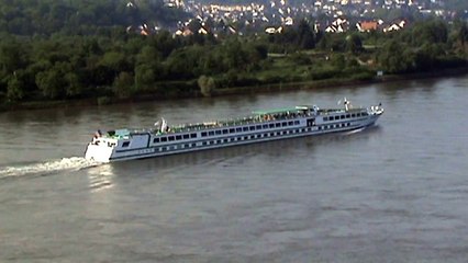 A police boat, freight barges and passenger ships on the river Rhine at the Bopparder Hamm