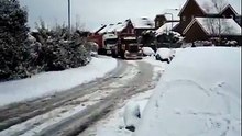 Big rig truck pulls 18 wheeler uphill in snow