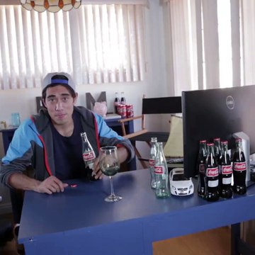 What happens with you blow into a coke bottle