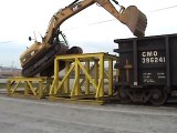 Cat 319D LN climbing onto rail car