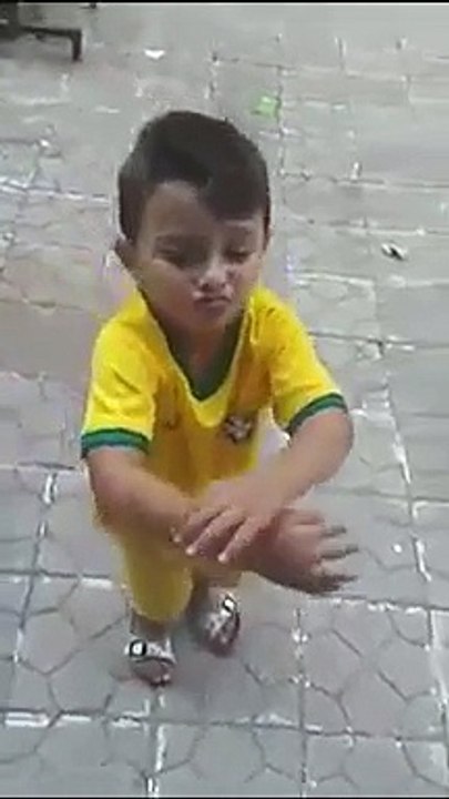 a cute boy dancing on an Arabic song