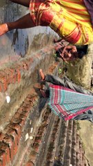 Boys are finding coins in Ganga river by rope with magnet.