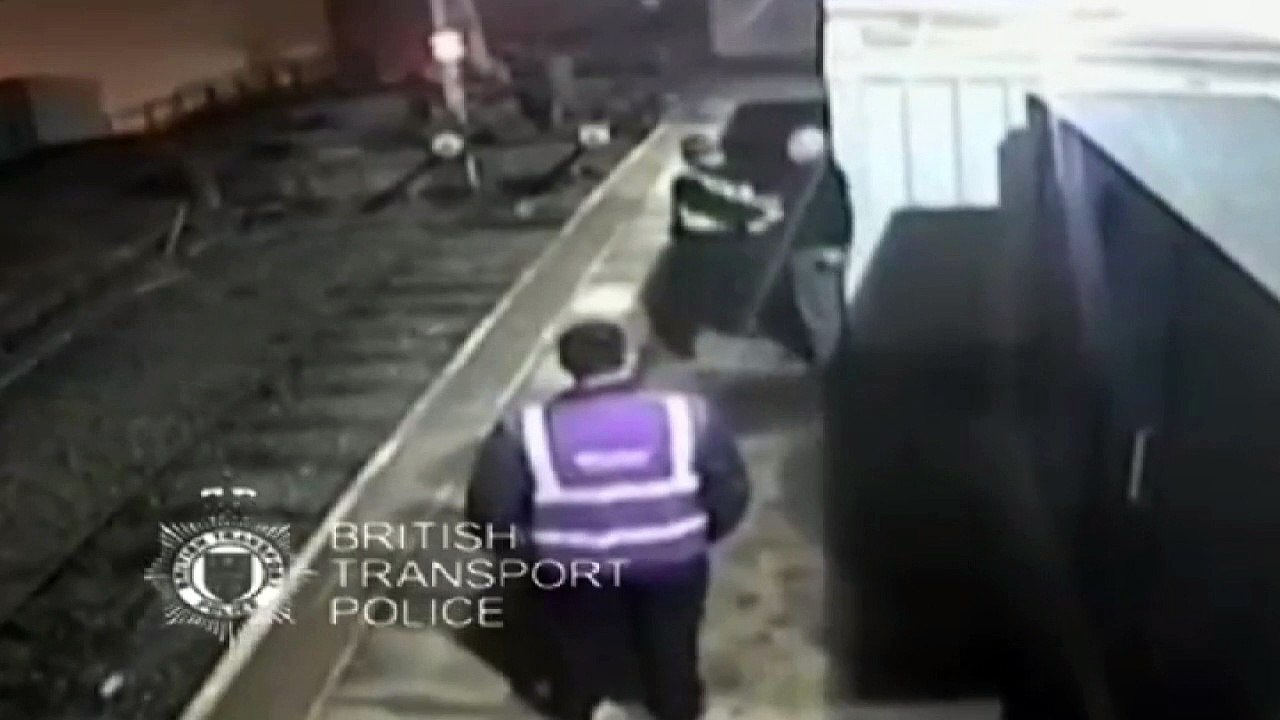 Footage shows man pushing police officer onto train tracks