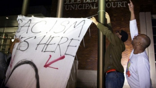 Two police officers shot outside Ferguson police station