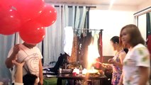 Des ballons gonflés à l'hélium explosent avec les bougies d'un gâteau d'anniversaire