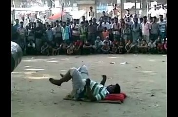 desi bazigar - desi acrobatics - man rolling drum on legs in air