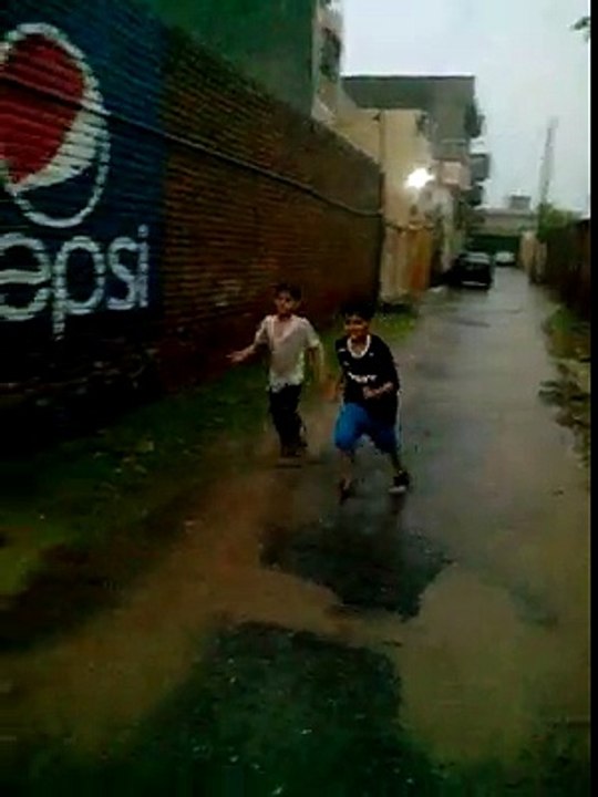 My friend Muhammad bakash son talla and tayyeb enjoy the rain on eid day