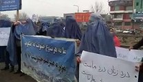 Afghan men wear burqas and march to support women rights