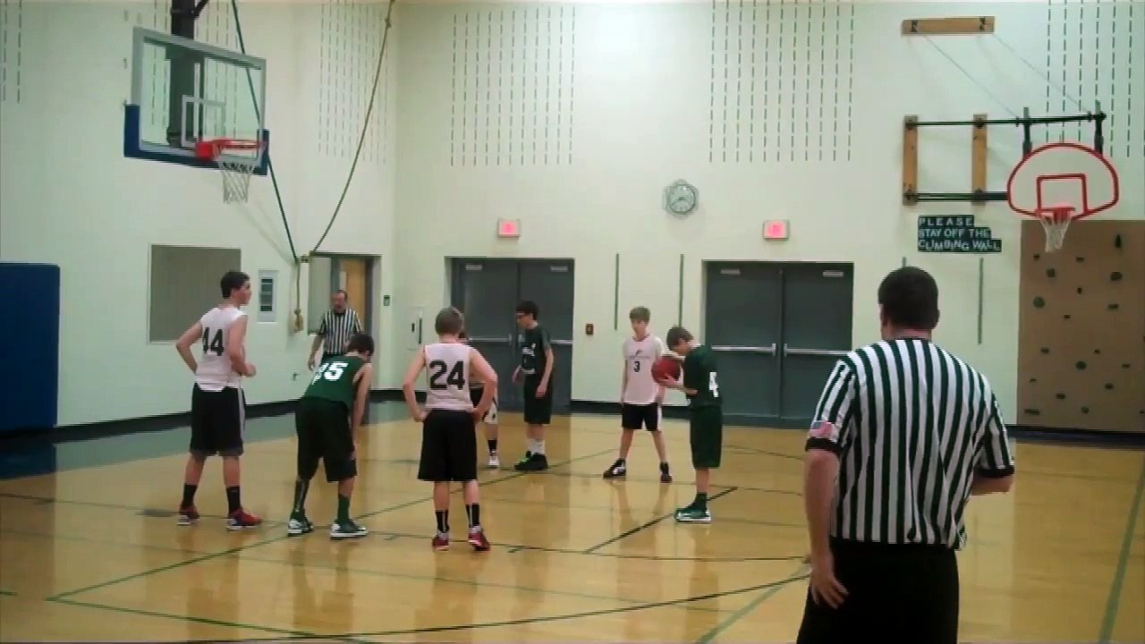Kid doing a full court buzzer beater basketball shot