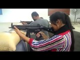 Pakistani Cadet girls firing with Military ammunition with Miltry Person