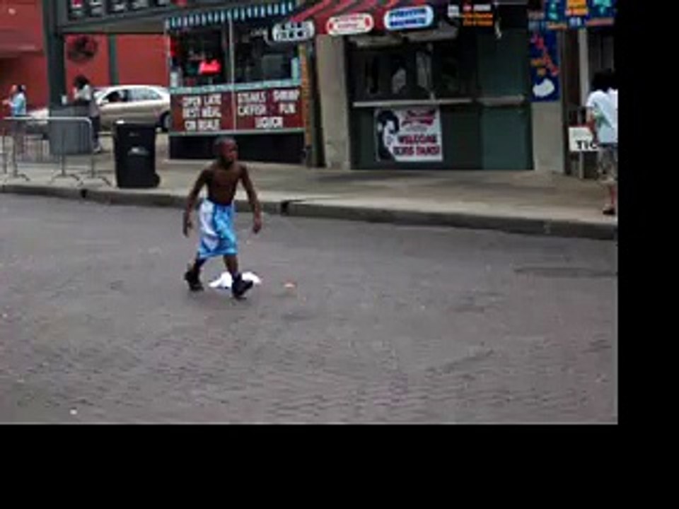 A kid does flips down Beale Street for tips Memphis Tennessee USA