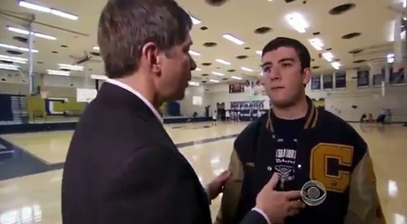 High School basketball player passes ball to mentally challenged player on the other team
