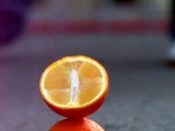 Orange crush in UltraSlo with a golf club in slow motion