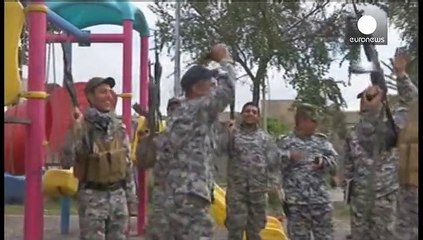 Iraqi soldiers and Shi'ite militia celebrate victory in Tikrit