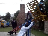 College boys having fun in the park by having a lad on the dangerous chair - funny video