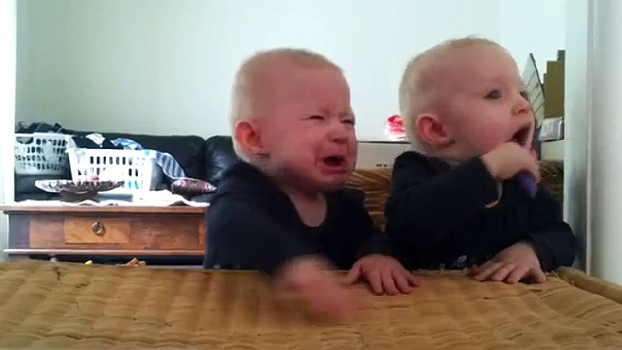 Twins fighting over a toothbrush