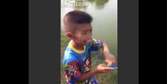 Boy catches fish with a toy fishing pole