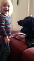 little girl gives kisses to the dog