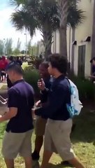 Two students fighting in front of their school