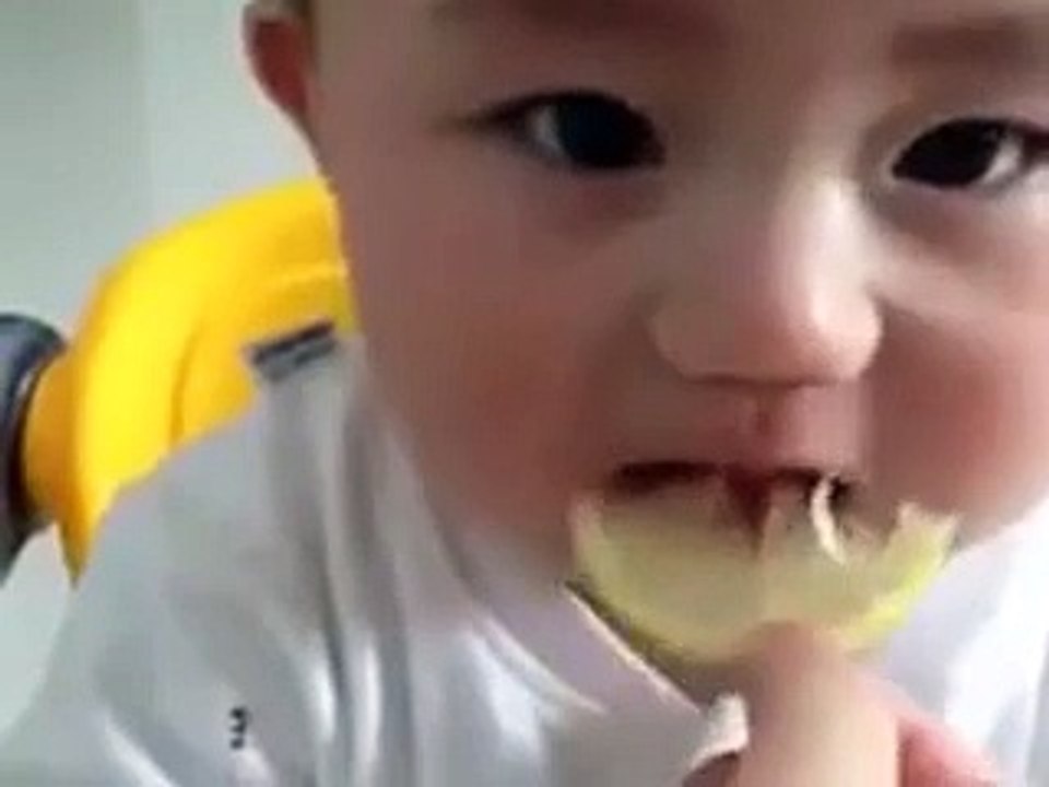 cute baby eate lemon and do fun