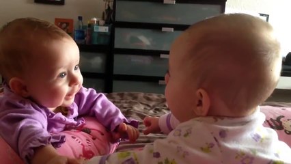 Twin babies talk and hold hands for the first time