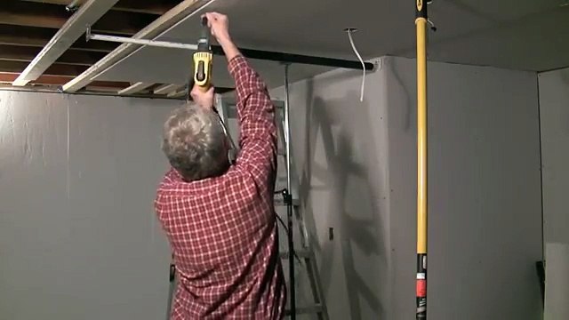 One man drywall installation on ceiling