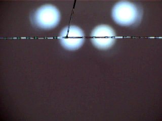 Perturbations de gouttes formées par une instabilité de Rayleigh-Plateau sur une fibre