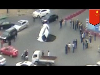 Massive sinkhole in Chinese road swallows car, occupants make a lucky escape