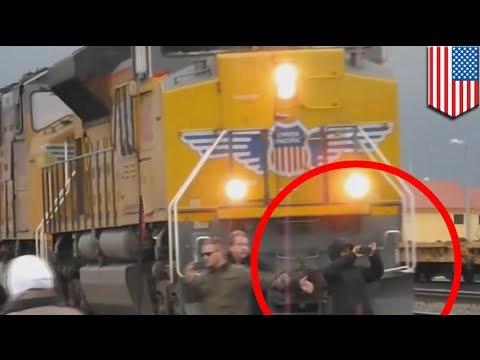 Young trainspotter is nearly flattened by a huge freight train