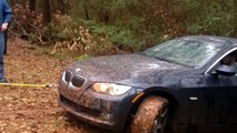 Subaru WRX STI pulling a BMW out of mud.