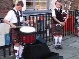 two scottish boys make bank with bagpipes & drum