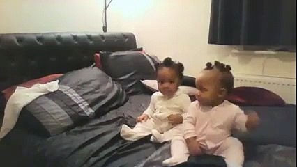 Twin Girls Are Just Sitting On The Bed