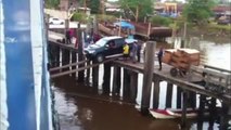 Attempting To Load A Car On A Ship Using Planks