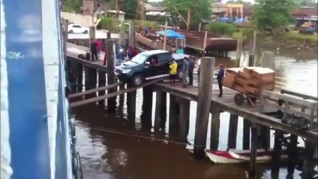 Attempting To Load A Car On A Ship Using Planks