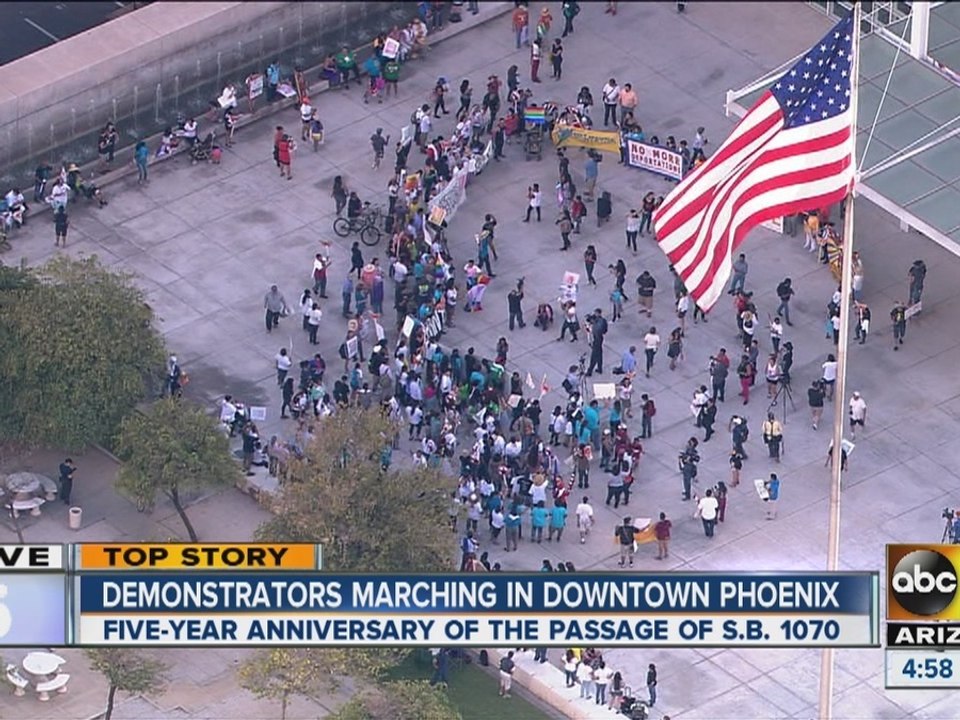 Demonstrators march in downtown Phoenix
