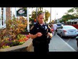Officer confronted after threatening to strike photographer