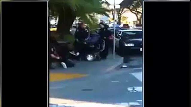 Cop filmed on cellphone trying to tip handicapped black man out of wheelchair