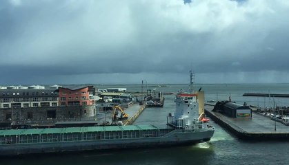 Giant Cargo Ship Squeezes Through Tiny Harbour Entrance