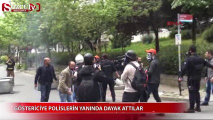 Göstericiye polislerin arasında dayak attılar