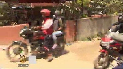 Nepali volunteers deliver quake aid on bike