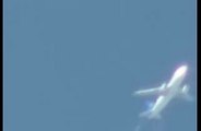 Fast UFO filmed flying past airplane.