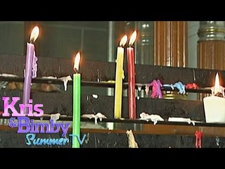 What virtues do colored candles symbolize?