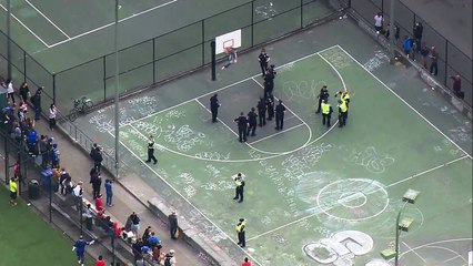 Shirtless man removed from basketball hoop