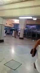 A Man Breaking The Glass Wall Which Is Surrounding The Safa Mountain In Makkah
