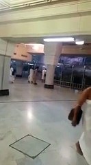 A man breaking the glass wall which is surrounding the Safa mountain in Makkah