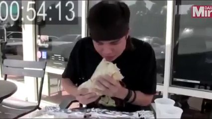 Watch extreme eater wince as he demolishes 8,000 calorie, 2kg burrito in less than two minutes