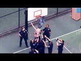 Shirtless man stuck in basketball hoop to protest Freddie Gray death in police custody - TomoNews