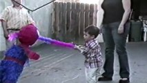 This kid doesn't want to break his pinata and hugs it... because it's a Spider-Man Pinata!